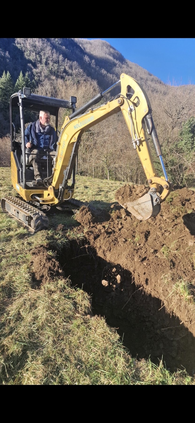 Excavator being used on mountain land near Vallico