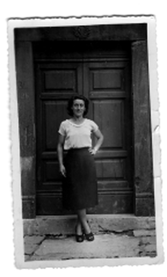 Young Flora standing in front of a church door in Vallico