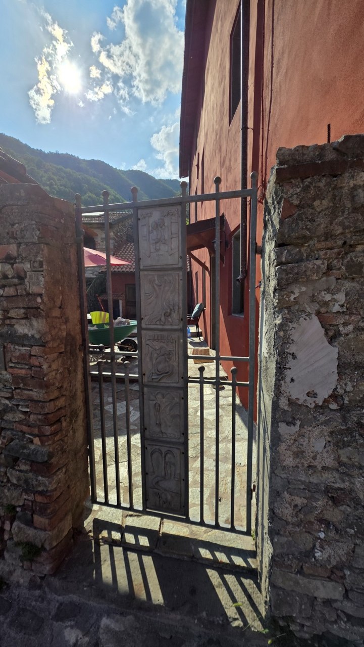 Metal gate and stone entrance at the Academy complex